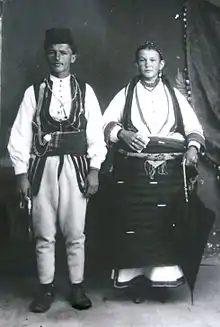 Couple of Demir Hisar, dressed in folklore costume, photographed in the studio of the brothers Manaki in Bitola, 1916