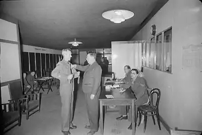 Regimental Sergeant Major Stilwell has his measurements taken for his demob suit by a tailor at the army's Demobilisation Clothing Depot at Olympia, London.