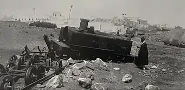 A man inspects the derailed Decauville locomotive at the scene of the attack that served as the pretext for the French bombardment of Casablanca in 1907.