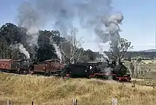 Queensland Rail heritage locos of the PB15, C17 and BB18¼ classes haul a special train for the 125th anniversary of QR on the Little Liverpool Range, west of Grandchester, July 1990.