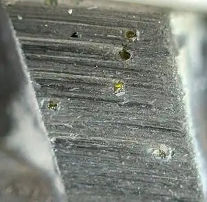 A polished metal blade embedded with small diamonds