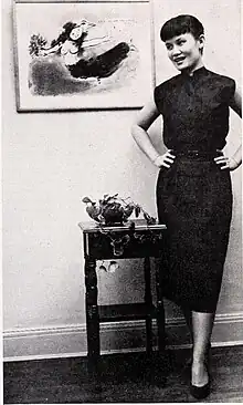 Chang beside a Marc Chagall lithograph, c. 1951