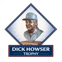 A bust of the Dick Howser Trophy in a blue diamond, with the words "DICK HOWSER TROPHY" below in white letters on a blue background.