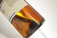 Diethyl ether liquid in a brown-tinted glass bottle