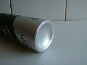 Picture of the bottom of an aerosol spray can.