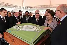 Brazilian president Dilma Rousseff, Pele and other people looking at stadium plans
