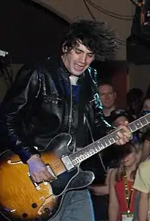 Anthony Rossomando playing guitar onstage.