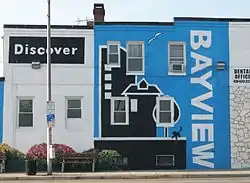 Discover Bayview mural on the side of a dental office on Eastern Avenue near the intersection with Dundalk Avenue.