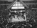 Inside of the arena with crowded seats during a ceremony performed by wrestlers