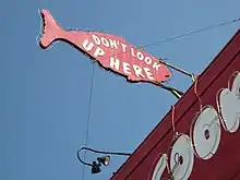 A sign in the shape of a red fish with the words, "Dont look here