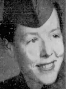 A smiling young white woman wearing a military cap