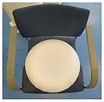 Top side of a ring pillow.The cover made of white terry cloth covers the recess.