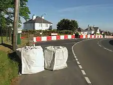 TT course safety devices at Douglas Road Corner, the right-hander entering Kirk Michael village