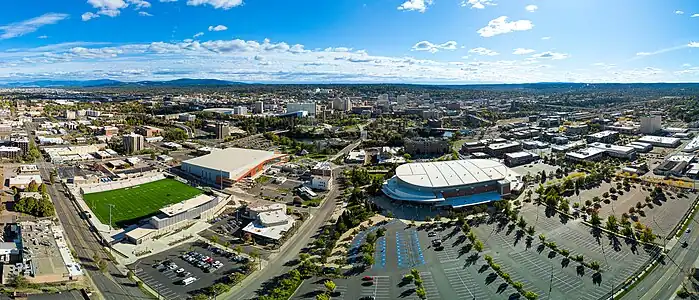 Aerial panorama photograph of downtown Spokane with prominent Spokane Public Facilities District structures in the near view