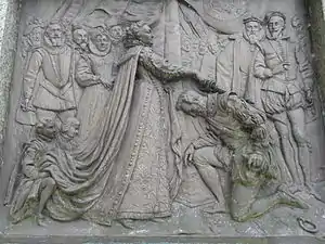 Drake receives knighthood from Queen Elizabeth. Bronze plaque by Joseph Boehm, 1883, base of Drake statue, Tavistock