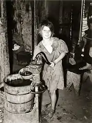 Drawing water from a hand pump, Oklahoma City