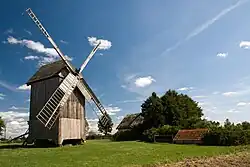 A historic windmill and a cottage in Drewnowo-Lipski