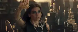 Dua Lipa with raising her cyborg arm with a apocalyptic city behind her