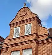 "curly pedimented gables... a little Dutch"