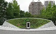 Color photograph of a stone structure covered in plants