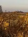 Abandoned farm. In the distance you can see the Belarusian farm with a water tower