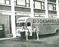 Library employees with bookmobile, outside of Parkway Towers.
