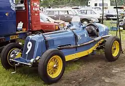 Bira's third ERA, chassis R12B Hanuman II, in the final Thai racing scheme of pale blue with yellow chassis rails and wheels. The Thai flag is placed in the subsidiary position, at the left leading edge of the car's bonnet, to represent the driver (it is also on the tail)