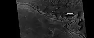 Wide view of mesa breaking up into rocks, as seen by HiRISE under HiWish program Parts of this image are shown enlarged in the next two images.