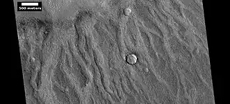 Channels made by the backwash from tsunamis, as seen by HiRISE. Tsunamis were probably caused by asteroids striking the ocean.