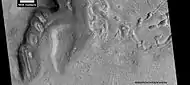Dipping layers, as seen by HiRISE under HiWish program Also, Ribbed Upper plains material is visible in the upper right of the picture.  It is forming from the upper plains unit, and in turn is being eroded into brain terrain.