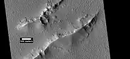 Layers and dark slope streaks in Lycus Sulci,  as seen by HiRISE under HiWish program