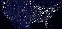 Nighttime satellite image of the contiguous United States showing light pollution in densely populated areas