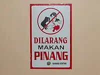 Sign in Indonesia saying that chewing betelnut is prohibited. Because of the mess, many places ban chewing betelnut. Notably, Port Moresby, the capital of Papua New Guinea, has a ban on buai. This buai ban is from Sentani Airport, Jayapura, Papua Province, Indonesia.