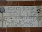 A tablet formed of five tiles of varying sizes, bordered by yellow and blue flowers in an art nouveau style