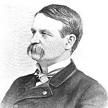Black and white photo of E. henry Powell, facing left