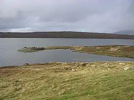An upland lake surrounded by rough grassland