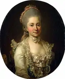 Portrait of a woman in a cream coloured silk gown overlain with lace and bows in the bodice. She wears a matching bow as a choker and her hair is adorned with flower garlands.