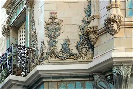 Thistles and curve-lined mascarons in decoration of Les Chardons building by Charles Klein in Paris (1903)