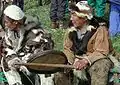 Elder men playing sealskin drum