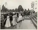 The Queen, wearing her coronation gown, arriving at Parliament House, Canberra to open the third session of the 20th Federal Parliament on 15 February 1954