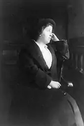 Image of a formally dressed woman, seated, around 1930.