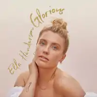 A photo of Henderson's face with the artist and song title written in gold script around her