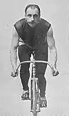 Male cyclist on a bicycle headed straight toward the camera