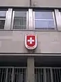 Plaque outside the embassy depicting the Coat of arms of Switzerland