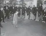 Emperor Shōwa greeted by officials and wrestlers in 1956.