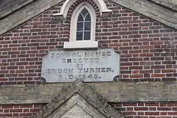 Stonework engraved "School house erected by Enoch Turner, A. D. 1843"