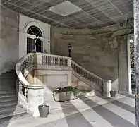 The staircase within the porte-cochere