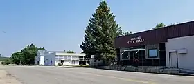 Two buildings on a county highway, one of which is labeled Erhard City Hall.