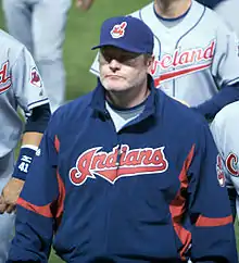 A man in a blue jacket with the word "Indians" written across the chest