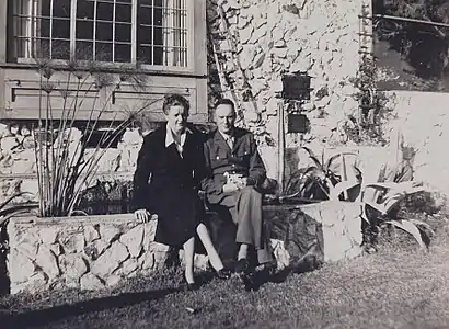 Chester Arthur III (Gavin Arthur), in uniform, and Esther Arthur sitting on a rock wall, 1942
